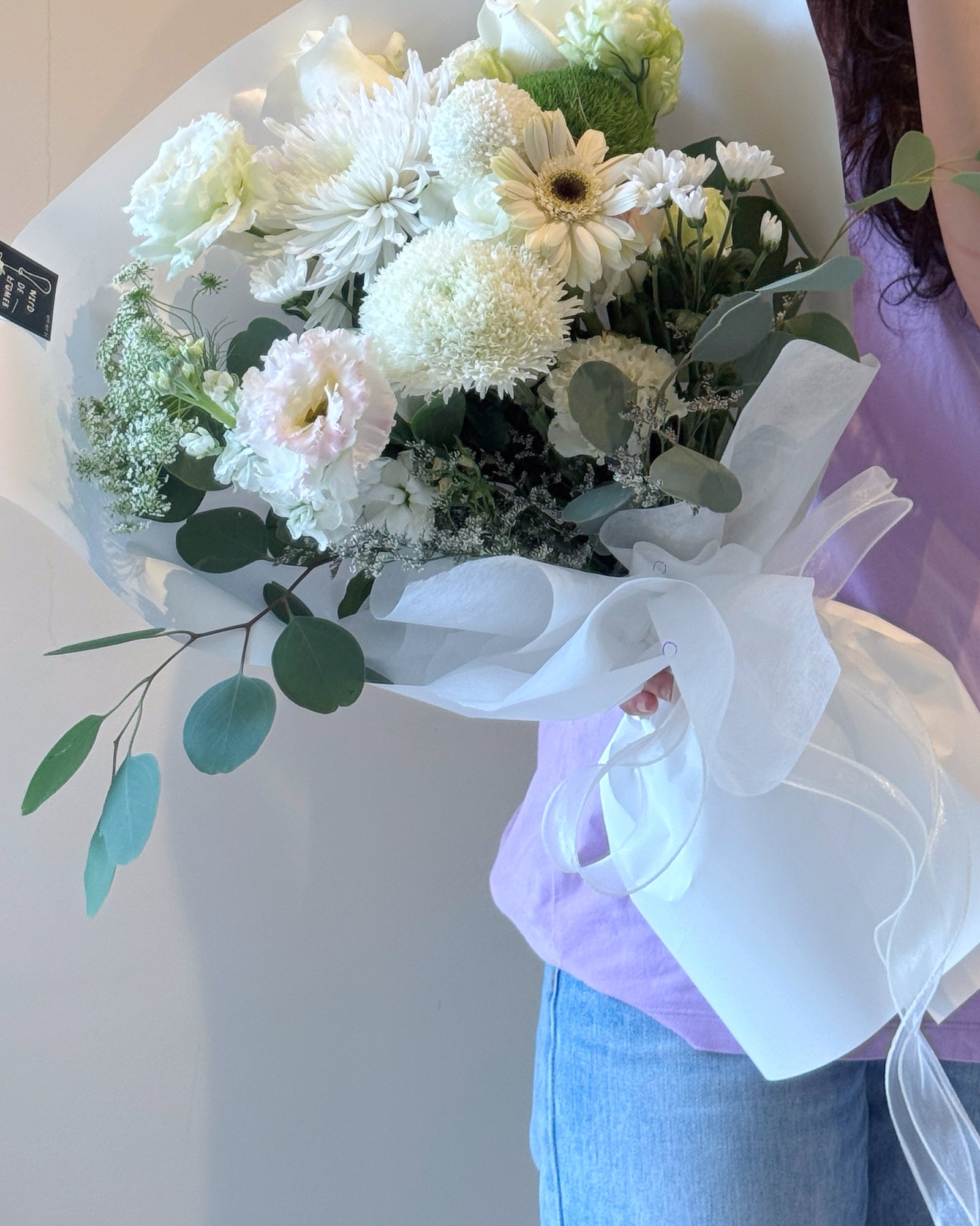 An ivory bridal bouquet bound in silk ribbon